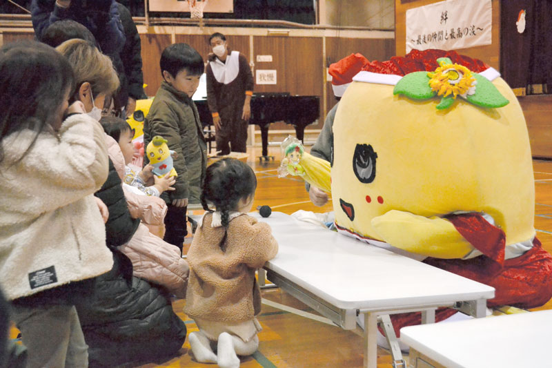 子どもにプレゼントを手渡すふなっしー＝２２日午後３時ごろ、船橋市立金杉台中学校
