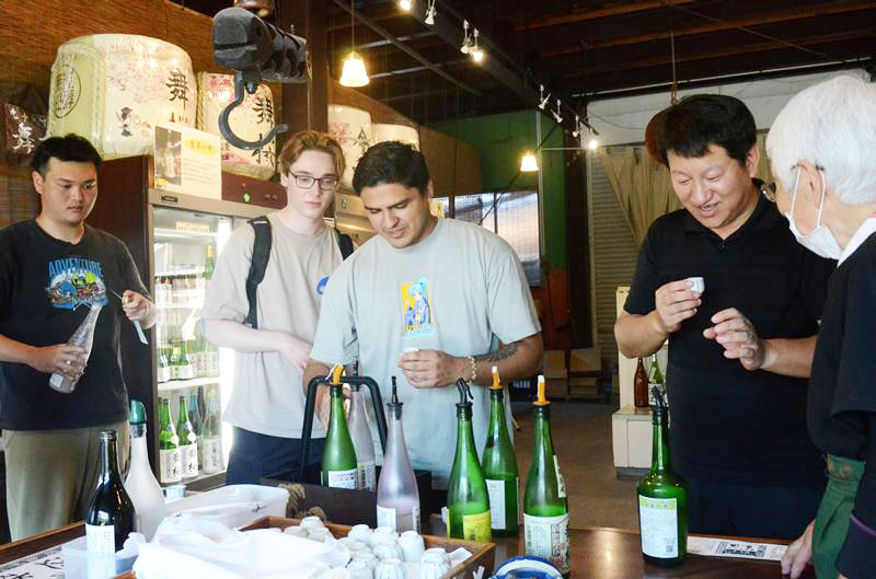 地元高校生が企画したツアーで試飲を楽しむ城西国際大の留学生=昨年7月