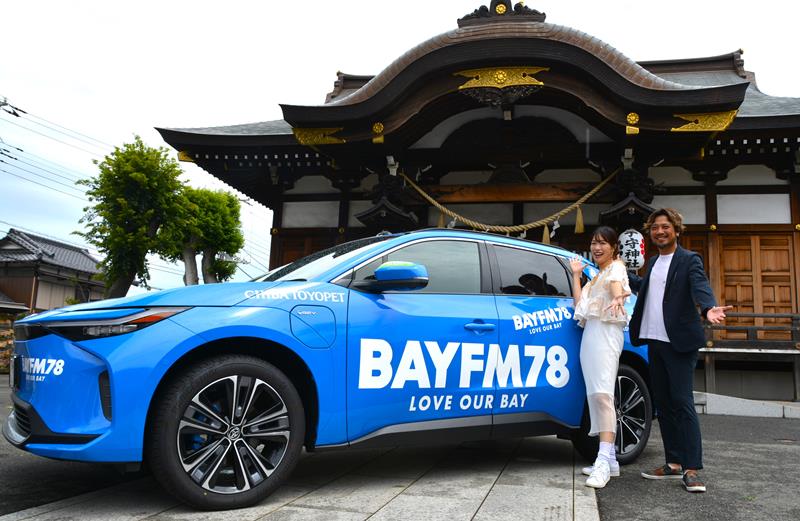 キャンペーンカーの前でポーズを取る（左から）奥宮さん、光永さん＝千葉市花見川区